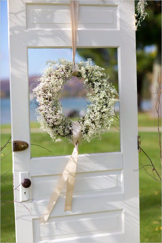 A paniculata wreath hanging from the wedding ceremony door photographed by Stephanie N Baker.