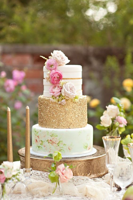 3-tiered gold wedding cake with flower details for an outdoor shabby chic wedding.