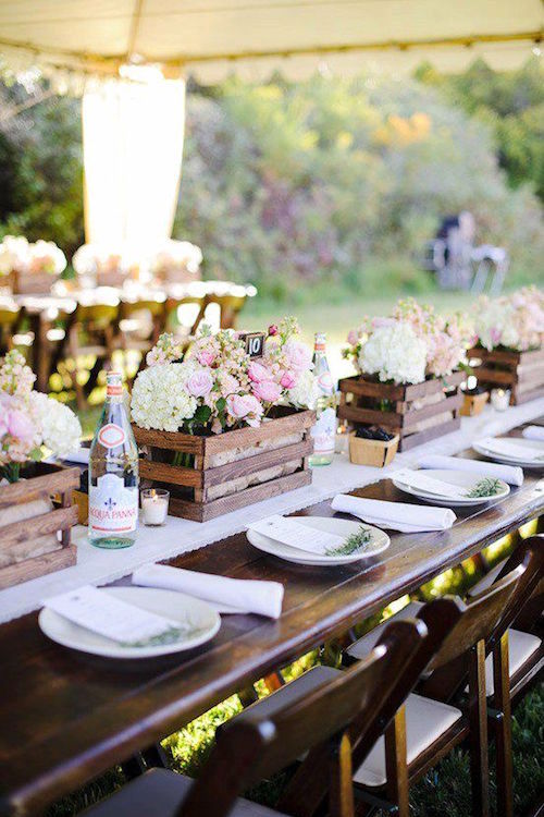 Love how the delicate blooms contrast against the country rustic wedding centerpieces.