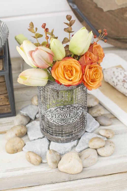 Gorgeous metal wire vases filled with tulips and sprigs for a rustic wedding.