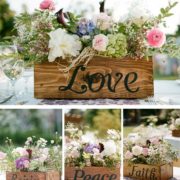 Wooden box centerpieces. Have each of the "love is..." engraved on each box.