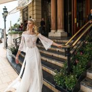 For the hipster bride, the alessandra rinaudo 2017 bridal brings you Bria - with off the shoulder three quarter bell sleeves lace heavily embellished bodice sexy sheath wedding dress lace back and a sweep train.