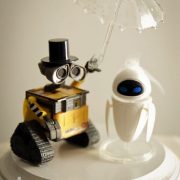 Why settle for a generic cake topper when you can create something truly personal and meaningful to you? Use action figures from toy stores and other creative sources for a one of a kind topper. Wall-E and Eve cake topper. Faith Michele Photography.