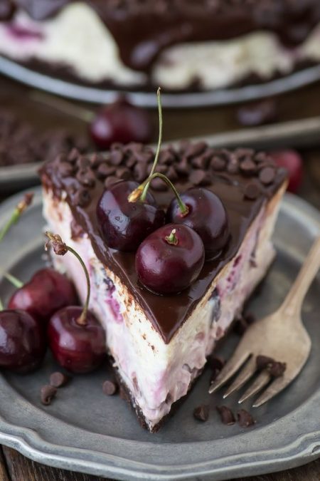 Fresh chocolate cherry cheesecake dripping with ganache. A delicate Holiday touch.