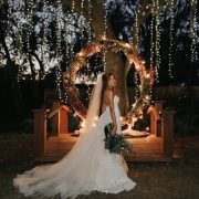 Drop the flowers and add string lights for a glowing giant wedding wreath backdrop.