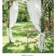 A simple arch made with white birch branches, fabric and dried flowers.