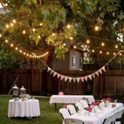 Folding tables and chairs, string lights and buntings for a very festive wedding in your own backyard.