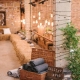 We love the rustic meets industrial decor vibe. Bales of hay, exposed brick and hanging Edison bulbs. Blankets in a basket favors make loving winter wedding ideas.