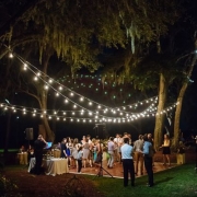 Wedding dance floor ideas that will make your heart sing. String lights at an outdoor reception at RiverOaks in Charleston. Photo: Clay Austin.