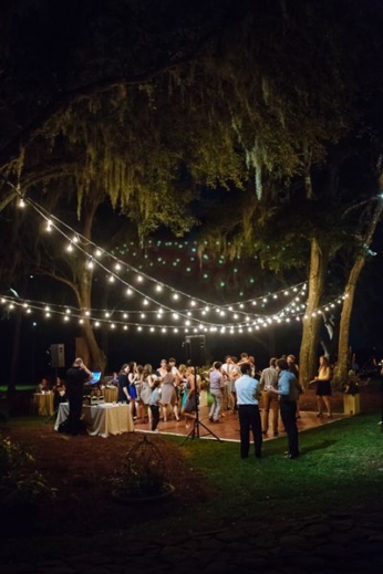 Wedding dance floor ideas that will make your heart sing. String lights at an outdoor reception at RiverOaks in Charleston. Photo: Clay Austin.